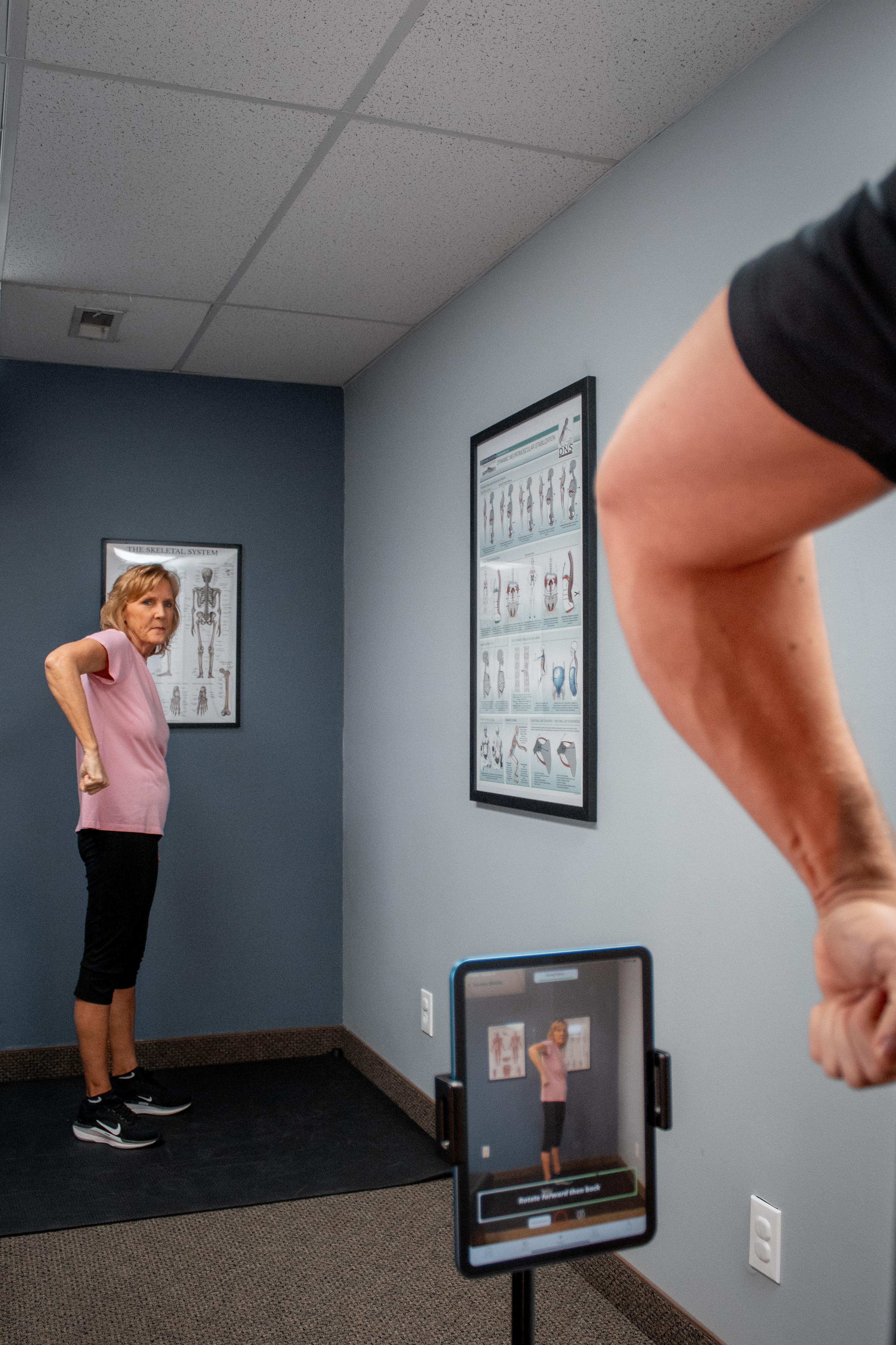 Dr. Mitch Israel guiding a client through a movement assessment at SYMYO Sports Therapy
